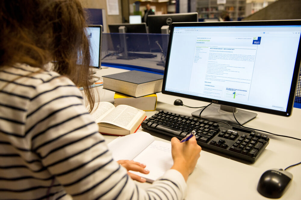 Person vor einem Computer mit Lernmaterialien