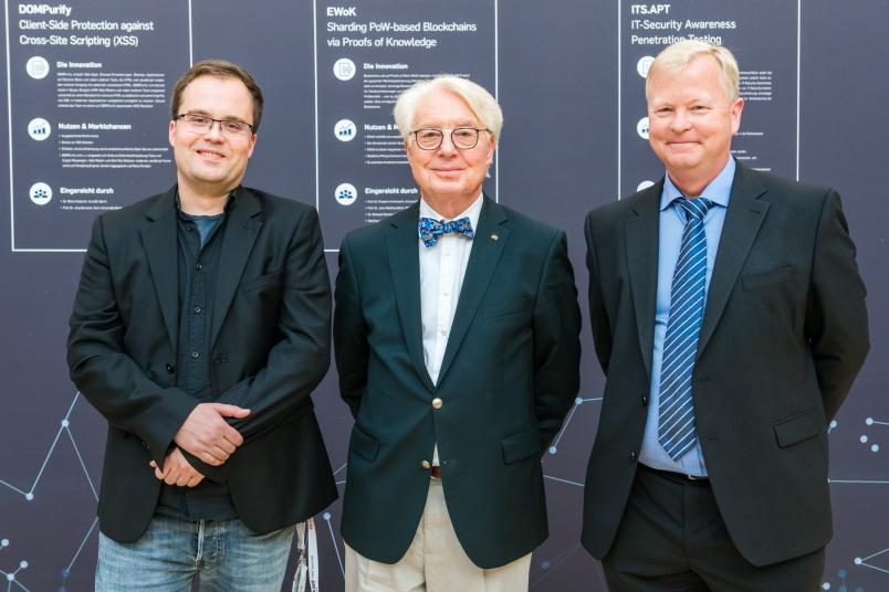 Jörg Schwenk vom Lehrstuhl für Netz- und Datensicherheit der RUB (rechts) und Mario Heiderich vom Unternehmen Cure 53 sind die Drittplatzierten im Wettbewerb – hier mit Stifter Horst Görtz (Mitte).