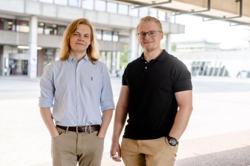 Zwei Studenten stehen nebeneinander.