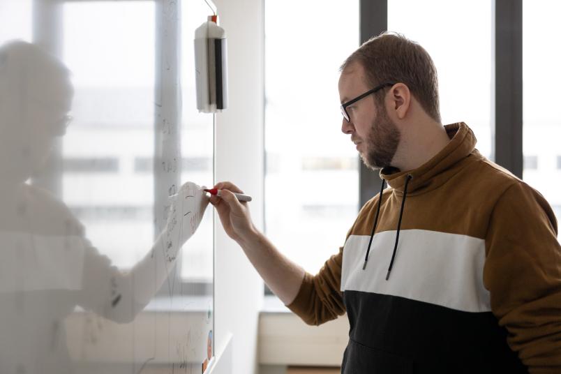 Mann rechnet an Whiteboard