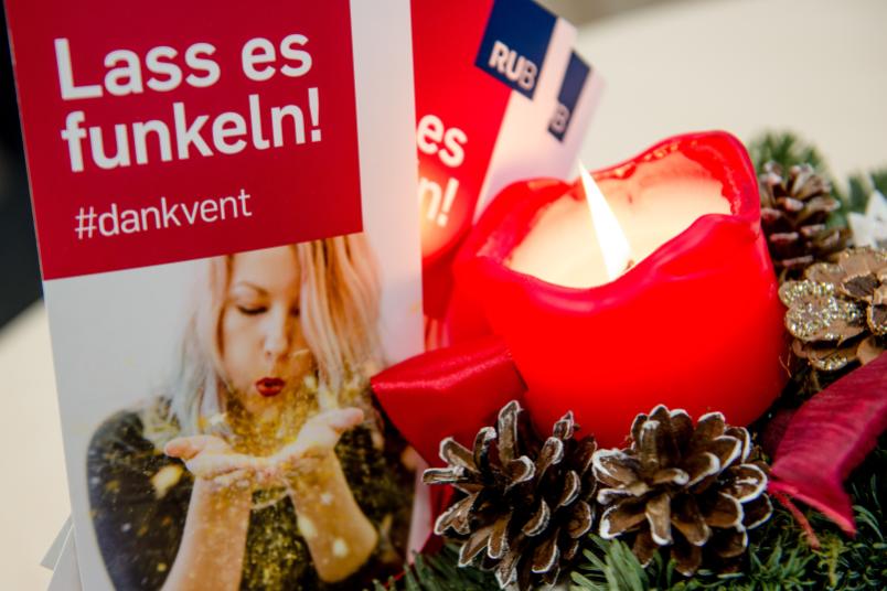 Eine rote Kerze in einem Adventsgesteck