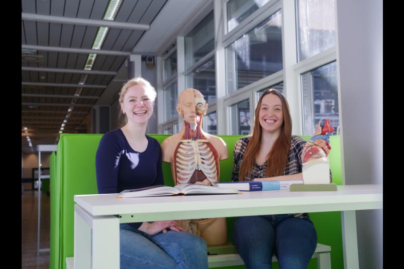 Zwei Studierende mit einem Skelett 