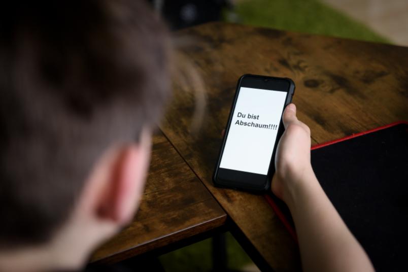 Handy mit Schimpfwort auf Display